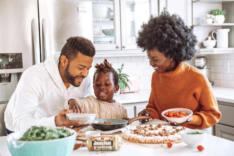 Family around dining table, having a meal