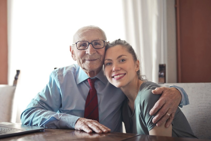 An elderly man with his granddaughter